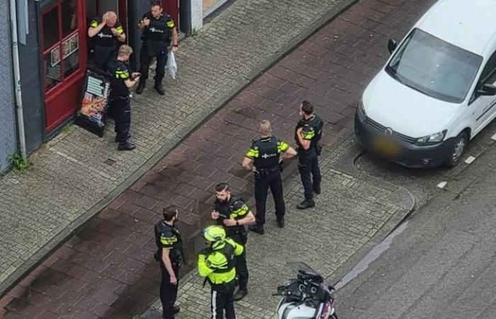 Officers with drawn weapons arrest three men in Tilburg