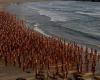 Thousands of naked people on Sydney beach against skin cancer