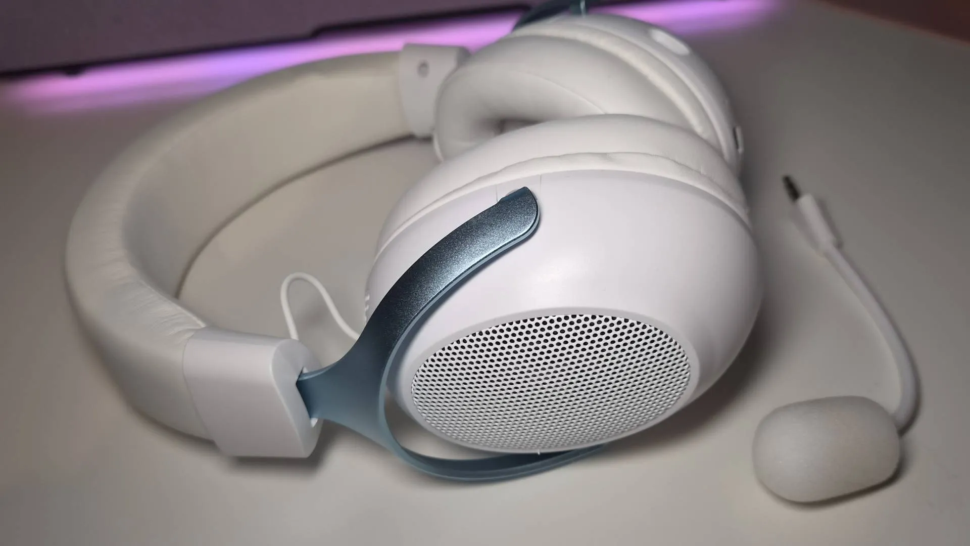 Photo of the Epomaker GX1 headset sitting on a white desk.