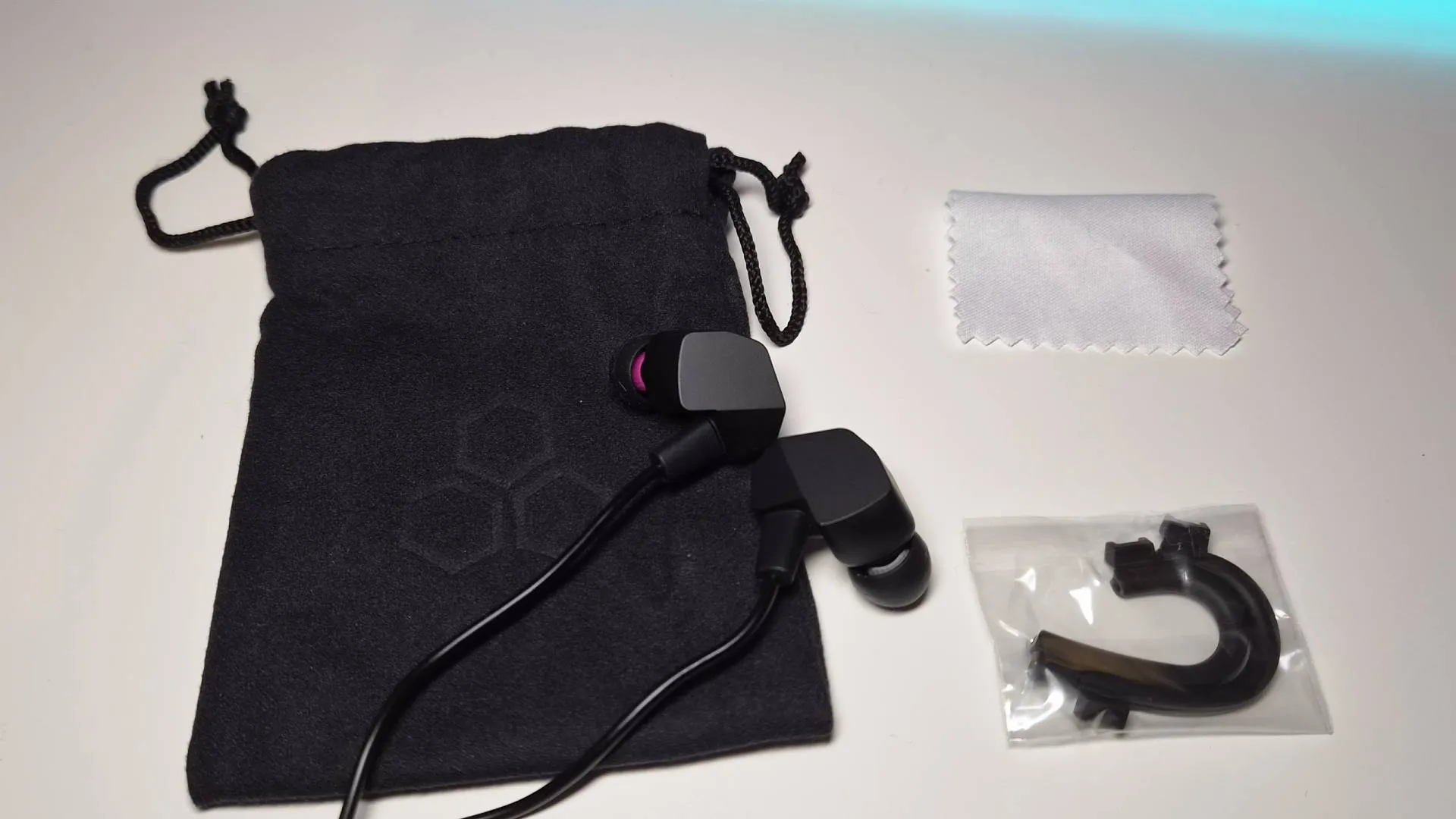 Photo of the accessories included with the Final VR3000 Gaming Earphones sitting on a white desk.