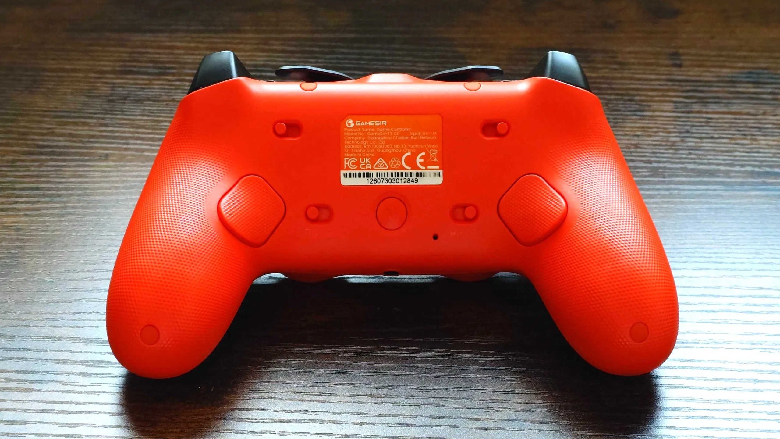 A photo of the rear of the GameSir Tarantula 8K controller showing thee rear buttons and four locking switches