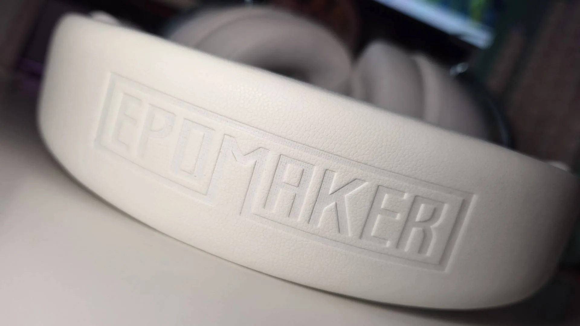 Photo of the Epomaker GX1 headset sitting on a white desk.
