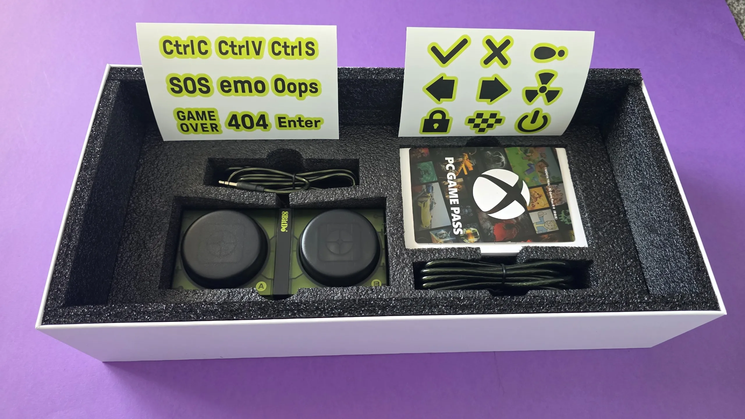 Open box showing stickers and game pass code